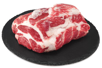 raw pork meat on black round stone plate isolated on white background. Clipping path and full depth of field