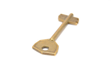 Vintage key on white background close-up. Texture, background, old, macro, wallpaper, metal, brass