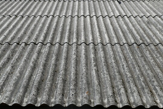 Dangerous asbestos in nature, old building materials used for roofing and wall covering. Asbestos dust in the environment. Health problems.
