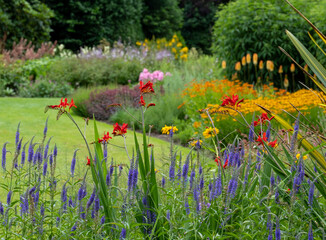 Mature garden influenced by the philosophy of naturalistic planting, with emphasis on layering,...
