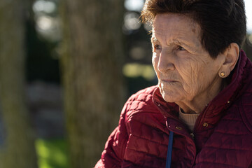 90 year old senior woman sad and looking forward pensive.