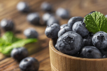 healthy blueberries on the table in a wooden bowl