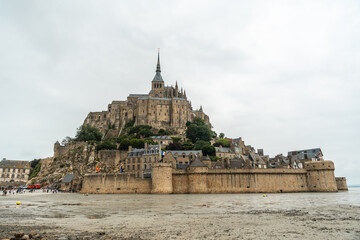 The famous Mont Saint-Michel Abbey reflected in the water at low tide, Normandy region, France