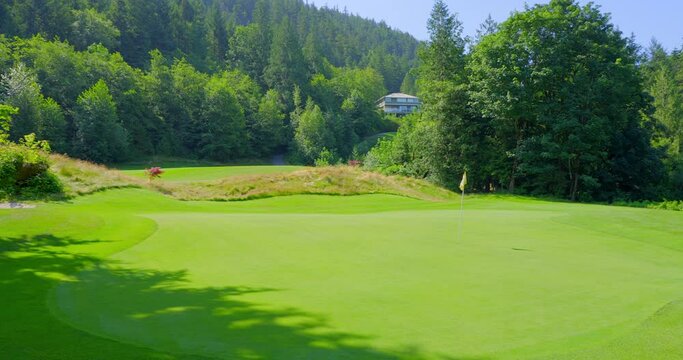 Establishing shot of golf course with gorgeous green and fantastic forest view in Vancouver, Canada, North America. Day time on May 2021. Still camera. ProRes 422 HQ.