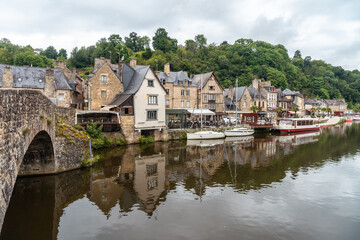 Fototapeta na wymiar Houses and boats on the Rance river in Dinan medieval village in French Brittany, France