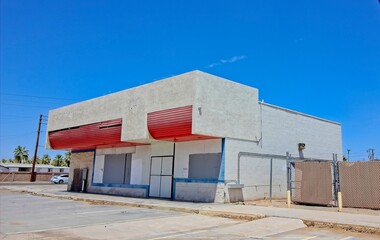 Abandoned Commercial Corner Building With Blocked Out Windows & Doors