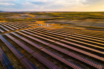 Massive solar power plant at sunset. Hundreds of moving solar panels ready to provide clean energy....