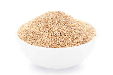 Close-Up of organic broken wheat (dalia or daliya ) roasted  in white ceramic bowl over white background