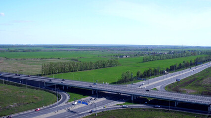 Fototapeta na wymiar Aerial view of highway and overpass in city on summer day