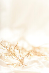 Golden branches and pearls nestled in silk.
