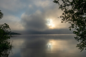 An early morning at Lac de Joux, Switzerland: Beautiful scenery with fog and the rising sun