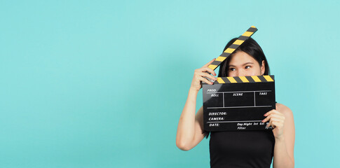 clapper board or movie clapperboard in teenage girl or woman hand with black and yellow color.it...