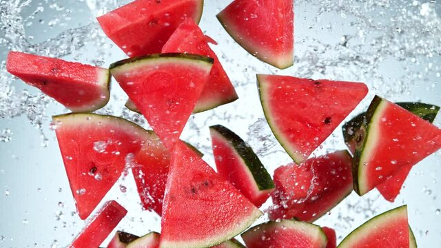 Super Slow Motion Shot of Flying Fresh Melon Cuts and Water Side Splash at 1000 fps.