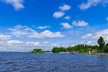waterfront of Ukraine city summer landscape of river shore with coast line and island in clear weather day time and blue sky background