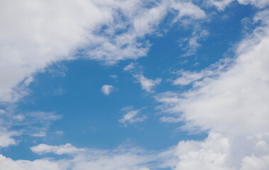 White clouds are floating on the dark blue sky