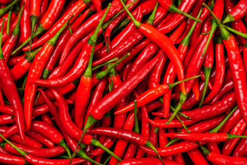 top view of a pile of fresh chili and ripe red peppers Background textures or templates to simulate or enter text.