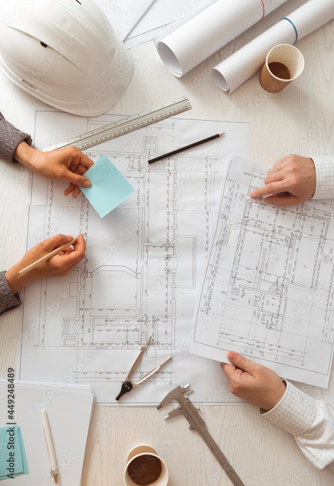 Poster architects work using sketches of blueprints. construction engineers are planning a building project