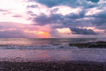 Pink sunset on the sea after a storm