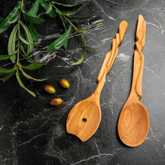 wooden spoons on the table with olives