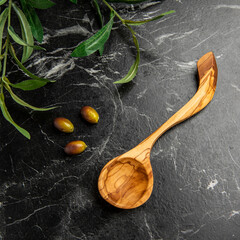 wooden spoons on the table with olives