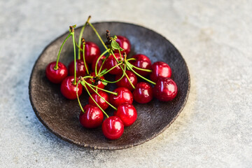 Chocolate cake with cherries on wooden background - obrazy, fototapety, plakaty