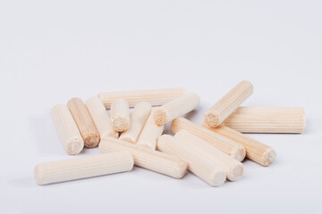 Wooden dowels for furniture on a white isolated background. 