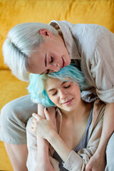 Lesbian Couple Having Rest At Home Hugging On Sofa In Cozy Room, Enjoying Time At Weekends, Feeling Love, Lgbt Members. Tender Sensual Ladies In Casual Wear Hugging, Copy Space. Focus On Blonde