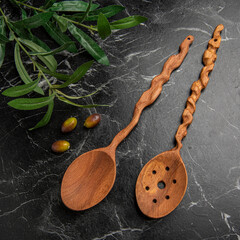 wooden spoons on the table with olives