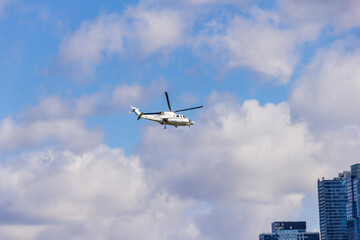 A helicopter flying on a blue sky