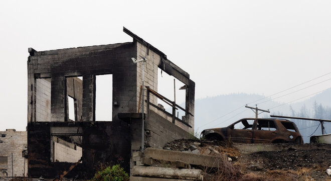 Fire Debris of Houses in a small town with smoke in sky. Caused by Forest Wildfires in Lytton, British Columbia, Canada. Natural Disaster