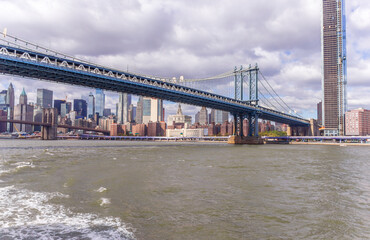 A picture of Manhattan Bridge in New York City, USA. In the picture one can see the East River, One Manhattan Square and Manhattan skyline