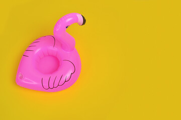 Figure of flamingo Inflatable, in pink color on yellow background.