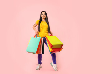 photo of happy charming woman hold shopping bags customer isolated on pink color background