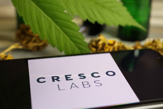 Viersen, Germany - January 9. 2021: Closeup of mobile phone screen with logo lettering of cannabinoid company cresco labs, blurred marijuana leaf