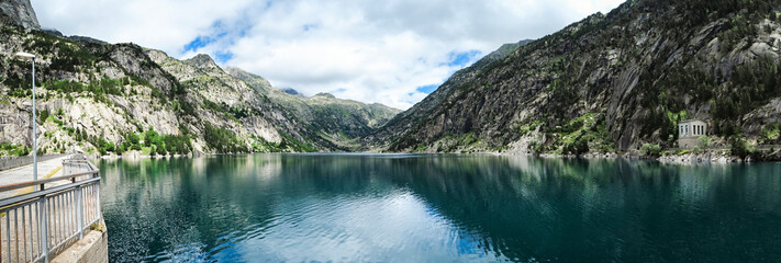 panoramic view of the Cavallers reservoir surrounded by high mountains, river Noguera de Tor in Ribagorza, Boí valley, in the Lleida Pyrenees, Catalonia, Spain