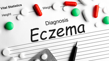 Diagnosis ECZEMA on paper, medicine pill, tablet and capsules.