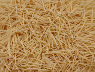 background closeup pasta texture . small vermicelli. raw small noodles