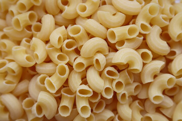 Dry raw yellow pasta. Italian pasta close-up.