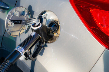 Fototapeta premium refueling the car, the gun in the fuel filler