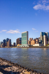 Fototapeta premium A picture of the United Nations building in New York City, USA. In the picture one can see the East River and Manhattan skyline