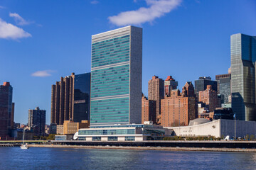 A picture of the United Nations building in New York City, USA. In the picture one can see the East River and Manhattan skyline