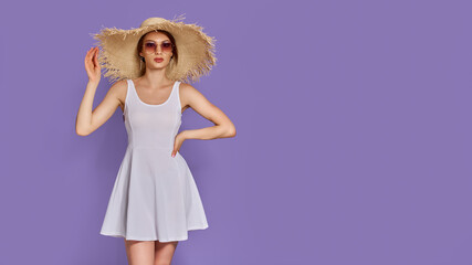 Photo of young fashion woman 20s wearing dress with straw hat and sunglasses isolated over violet background