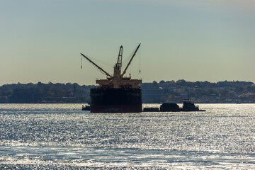 A boat shipping cargo between New York and New Jersey, USA - obrazy, fototapety, plakaty