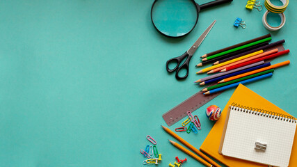School supplies on a blue background. View from above. Copy space.