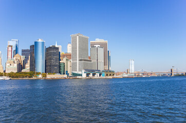 Naklejka premium A picture of Manhattan skyline with Battery Park and Maritime terminals, bridges and Brooklyn, NY, USA