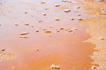 Fototapeta na wymiar Lake Koyashskoye. see the pink-orange water in which islands of salt float