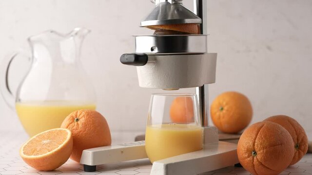 making fresh orange juice with squeezer