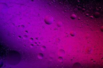 Abstract background similar to drops of water, the result of mixing water and oil. Full color. Abstract colorful circles wallpaper. Macro photograpy.