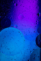 Abstract background similar to drops of water, the result of mixing water and oil. Full color. Abstract colorful circles wallpaper. Macro photograpy.