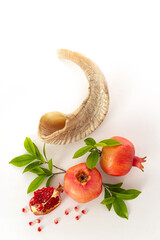 Rosh hashanah (jewish New Year holiday) concept -  shofar (horn) and pomegranate on white background. Traditional symbols - obrazy, fototapety, plakaty